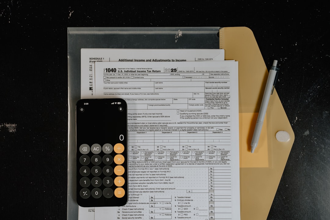 calculator-and-pen-on-tax-forms-sdfe8a0t-x8
